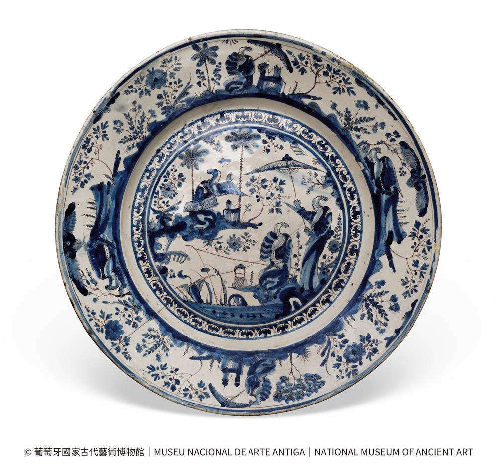 <p><span style="color: rgb(8, 8, 9); font-family: "Segoe UI Historic", "Segoe UI", Helvetica, Arial, sans-serif; font-size: 15px;">展品編號︰79</span><br class="html-br" style="color: rgb(8, 8, 9); font-family: "Segoe UI Historic", "Segoe UI", Helvetica, Arial, sans-serif; font-size: 15px;" />
<br class="html-br" style="color: rgb(8, 8, 9); font-family: "Segoe UI Historic", "Segoe UI", Helvetica, Arial, sans-serif; font-size: 15px;" />
<span style="color: rgb(8, 8, 9); font-family: "Segoe UI Historic", "Segoe UI", Helvetica, Arial, sans-serif; font-size: 15px;">白地藍彩人物紋陶盤</span><br class="html-br" style="color: rgb(8, 8, 9); font-family: "Segoe UI Historic", "Segoe UI", Helvetica, Arial, sans-serif; font-size: 15px;" />
<span style="color: rgb(8, 8, 9); font-family: "Segoe UI Historic", "Segoe UI", Helvetica, Arial, sans-serif; font-size: 15px;">葡萄牙 里斯本</span><br class="html-br" style="color: rgb(8, 8, 9); font-family: "Segoe UI Historic", "Segoe UI", Helvetica, Arial, sans-serif; font-size: 15px;" />
<span style="color: rgb(8, 8, 9); font-family: "Segoe UI Historic", "Segoe UI", Helvetica, Arial, sans-serif; font-size: 15px;">17世紀 下半葉</span><br class="html-br" style="color: rgb(8, 8, 9); font-family: "Segoe UI Historic", "Segoe UI", Helvetica, Arial, sans-serif; font-size: 15px;" />
<span style="color: rgb(8, 8, 9); font-family: "Segoe UI Historic", "Segoe UI", Helvetica, Arial, sans-serif; font-size: 15px;">葡萄牙國家古代藝術博物館</span><br class="html-br" style="color: rgb(8, 8, 9); font-family: "Segoe UI Historic", "Segoe UI", Helvetica, Arial, sans-serif; font-size: 15px;" />
<br class="html-br" style="color: rgb(8, 8, 9); font-family: "Segoe UI Historic", "Segoe UI", Helvetica, Arial, sans-serif; font-size: 15px;" />
<span style="color: rgb(8, 8, 9); font-family: "Segoe UI Historic", "Segoe UI", Helvetica, Arial, sans-serif; font-size: 15px;">此葡萄牙釉陶盤採用 “細紋飾” 風格,結合鈷藍與褐彩裝飾。口沿繪持傘華人、花卉及東方建築等元素,中心巴洛克式邊框內為山水人物圖,展現17世紀葡萄牙陶藝吸收中國紋樣的典型範例。</span><br class="html-br" style="color: rgb(8, 8, 9); font-family: "Segoe UI Historic", "Segoe UI", Helvetica, Arial, sans-serif; font-size: 15px;" />
<br class="html-br" style="color: rgb(8, 8, 9); font-family: "Segoe UI Historic", "Segoe UI", Helvetica, Arial, sans-serif; font-size: 15px;" />
<span style="color: rgb(8, 8, 9); font-family: "Segoe UI Historic", "Segoe UI", Helvetica, Arial, sans-serif; font-size: 15px;">其中持傘人形象應受當時盛行的“陽傘夫人”瓷器影響,“陽傘夫人”形象源自歐洲,加入了中國的花草鳥蝶等吉祥象徵,反映出西方對東方情調的幻想與當時流行時尚,展現了東西方跨文化互動的珍貴歷史。</span></p>